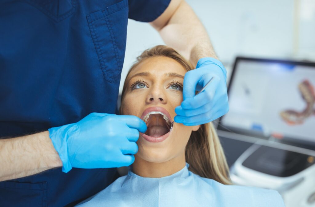 Dentist performing a dental exam on a female patient.