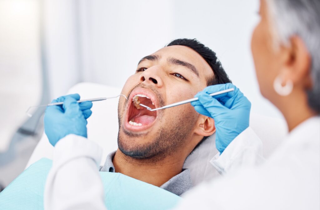 Patient receiving dental scaling during a routine cleaning.