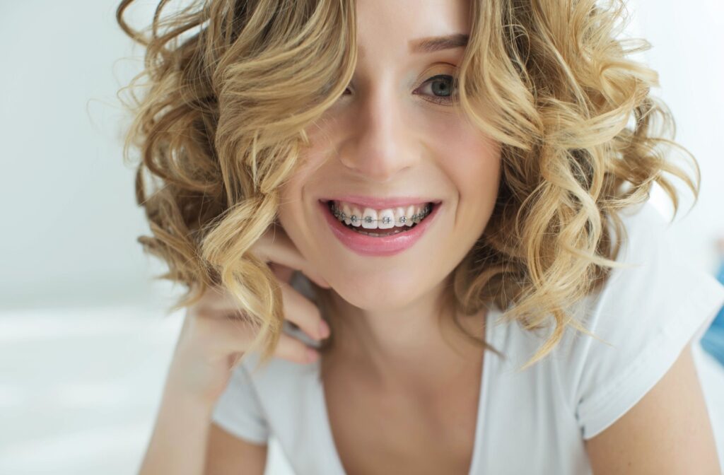 Young smiling blonde woman showing her braces.